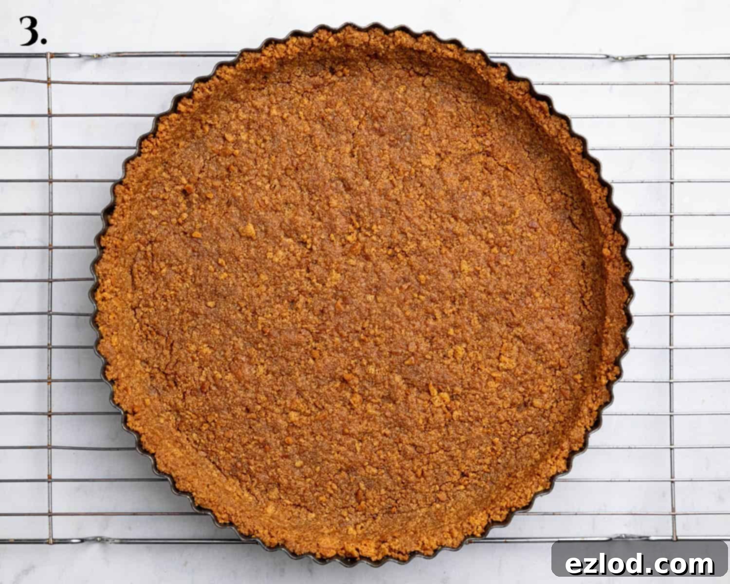 Zesty Vegan Cranberry Curd Tart 8 Step 3: The pre-baked gingernut tart base, golden and firm, in a tart tin.