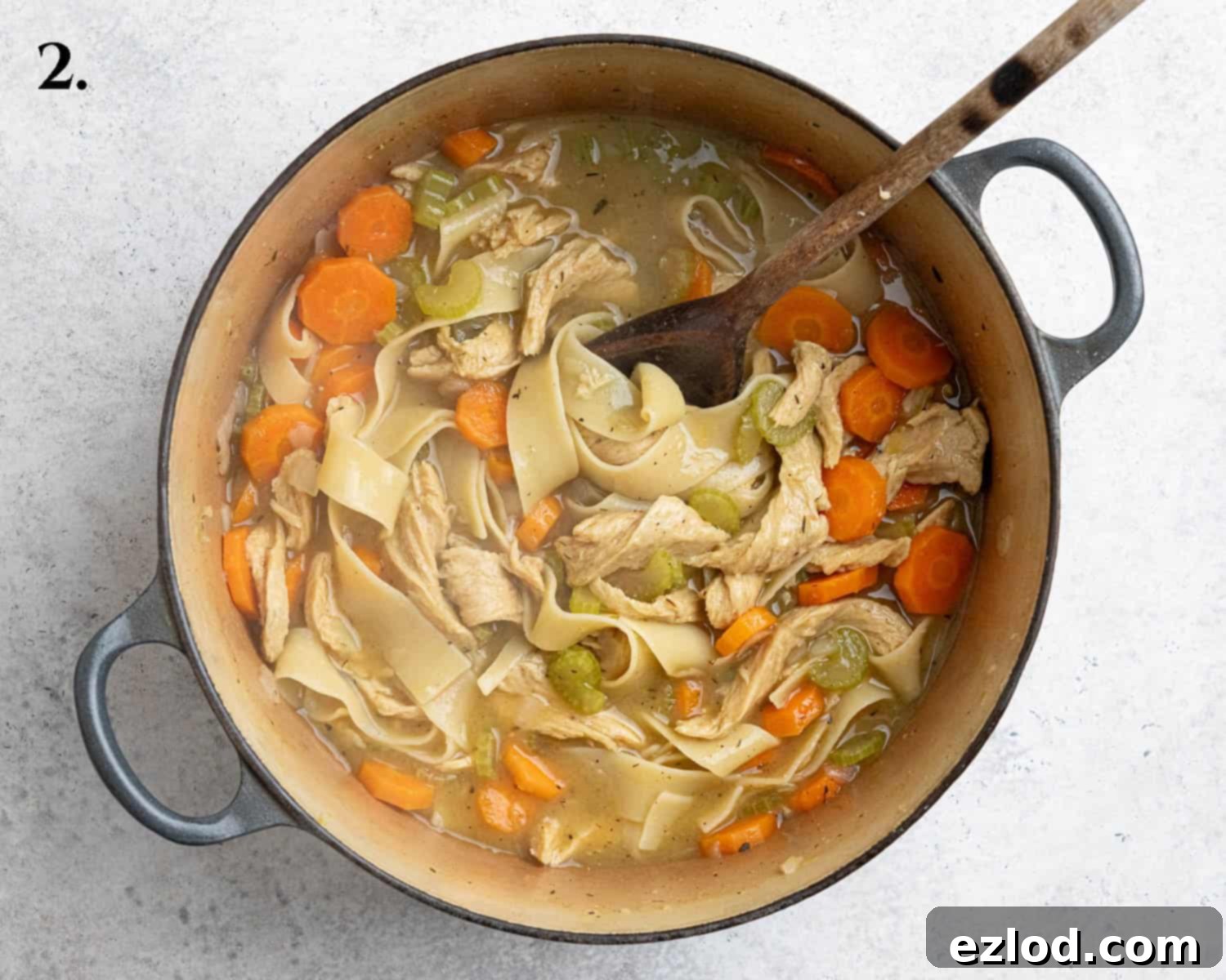 Plant-Based Chicken Noodle Soup 6 Step-by-step image showing the completed vegan chicken noodle soup simmering in a large pot, ready to be served.