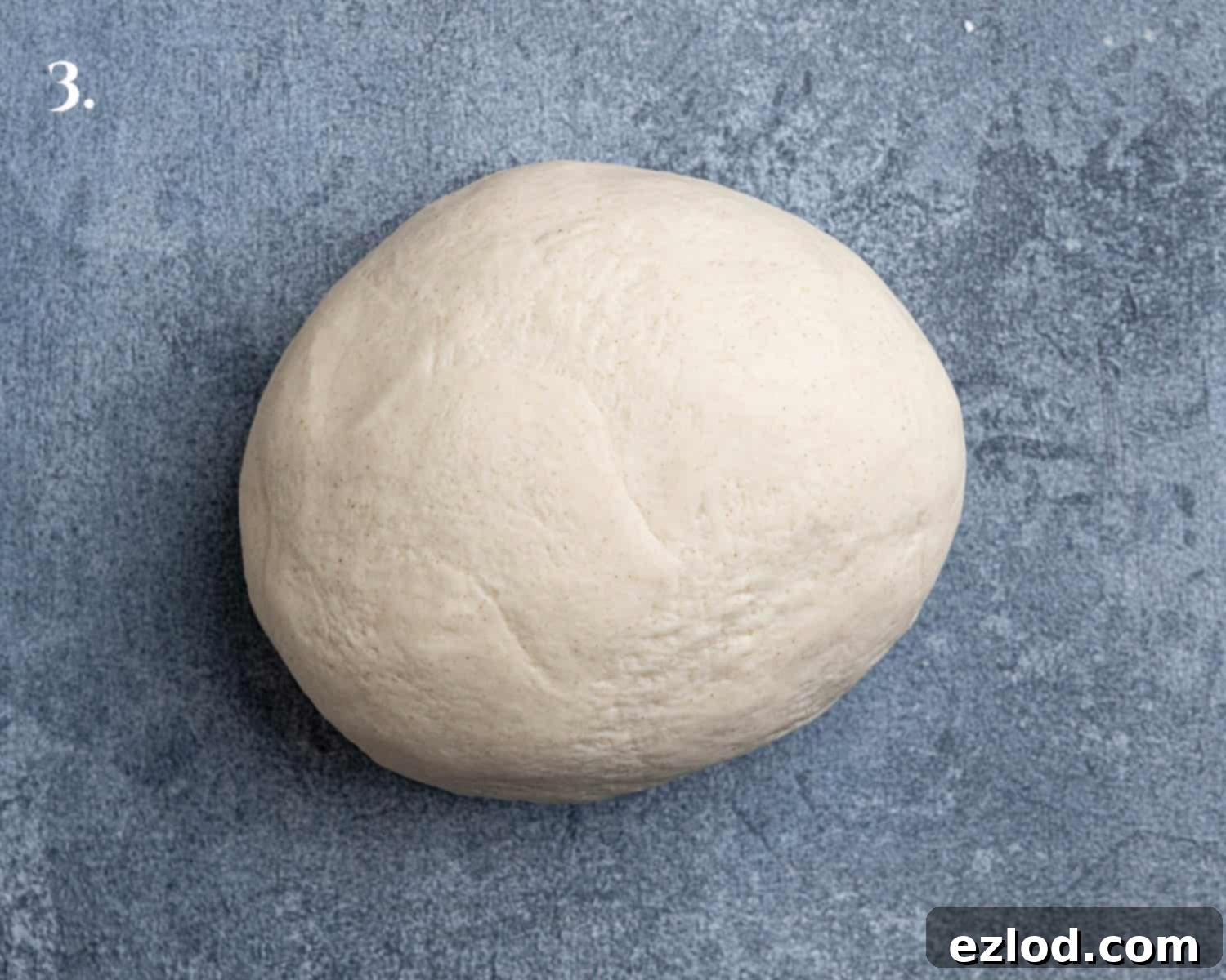 Velvety Gochujang Cream Pasta with Vegan Scissor Tofu 7 Step 3, the smooth, kneaded dough resting on a surface.