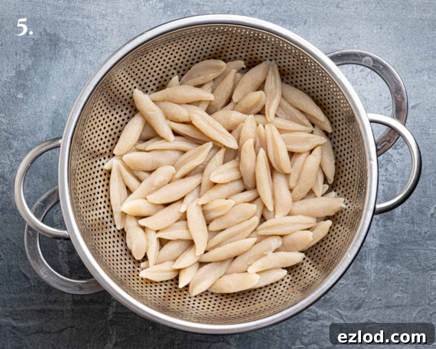 Velvety Gochujang Cream Pasta with Vegan Scissor Tofu 9 Step 5, the cooked tofu pasta noodles draining in a colander.