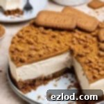 Decadent Vegan Biscoff Cheesecake 13 Vegan Biscoff cheesecake with a couple of slices removed, showcasing its creamy layers.