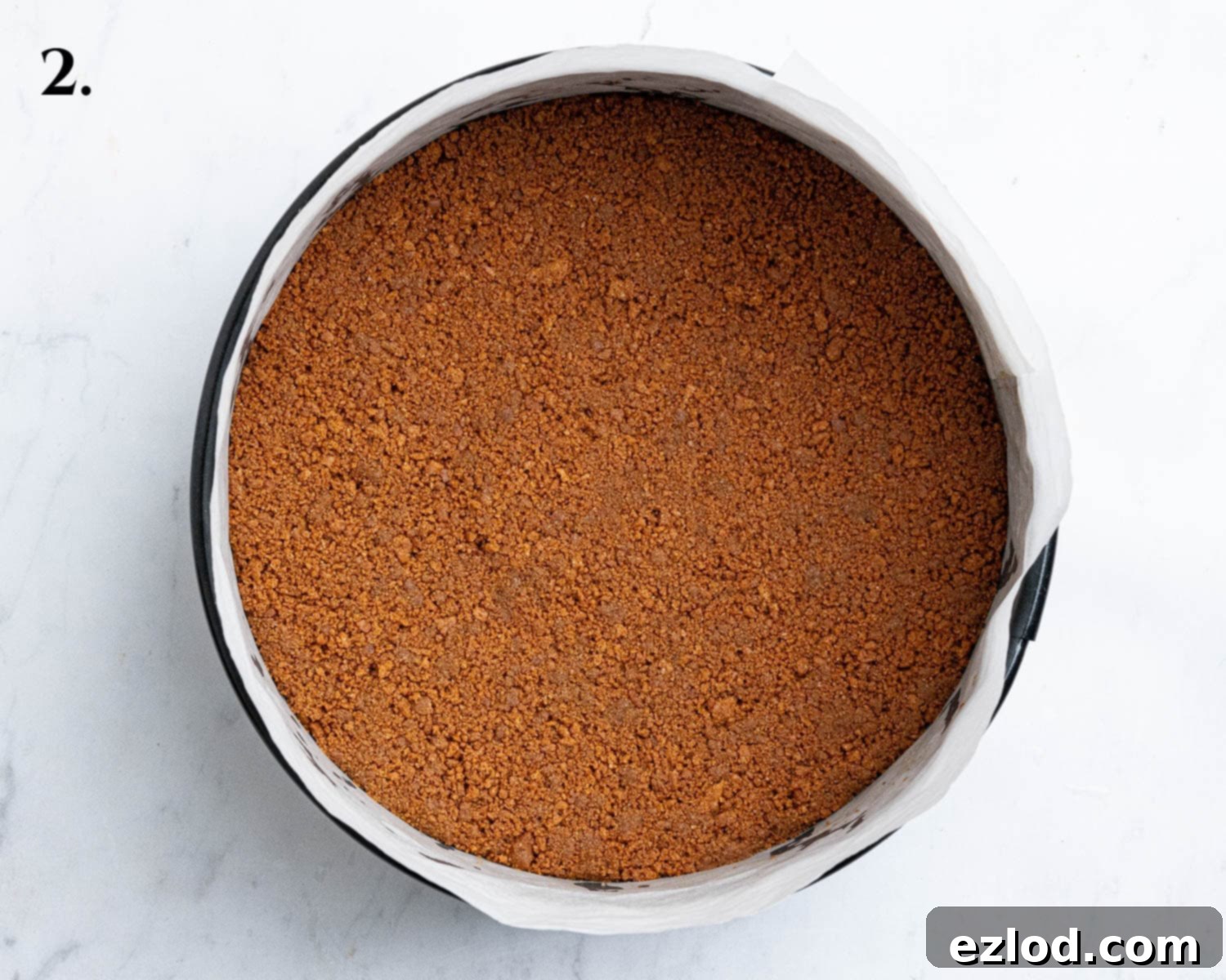 Decadent Vegan Biscoff Cheesecake 6 Step 2: The prepared Biscoff cookie base firmly pressed into a lined springform cake tin.