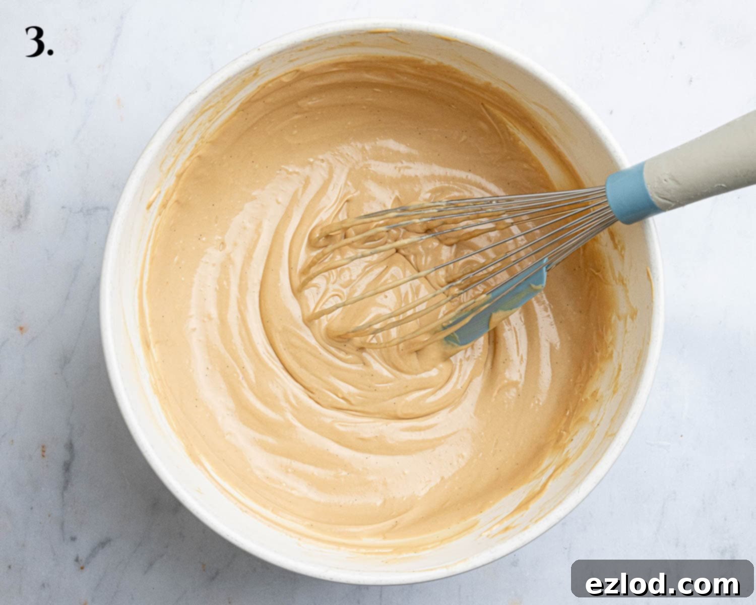 Decadent Vegan Biscoff Cheesecake 7 Step 3: The blended Biscoff spread, vegan cream cheese, yogurt, lemon juice, and vanilla extract in a mixing bowl.