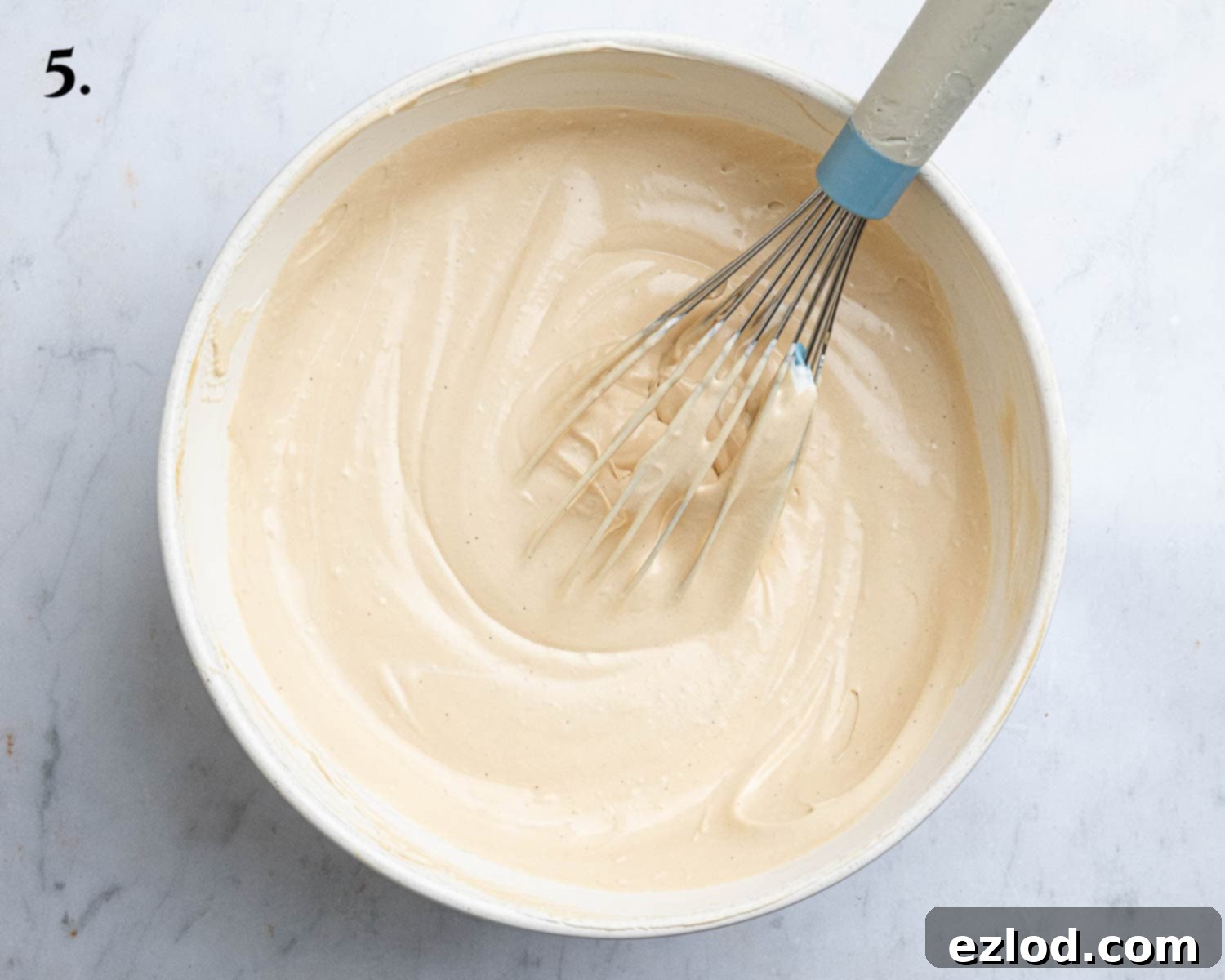 Decadent Vegan Biscoff Cheesecake 9 Step 5: The complete cheesecake filling, a light and creamy mixture, is now ready in a large bowl.