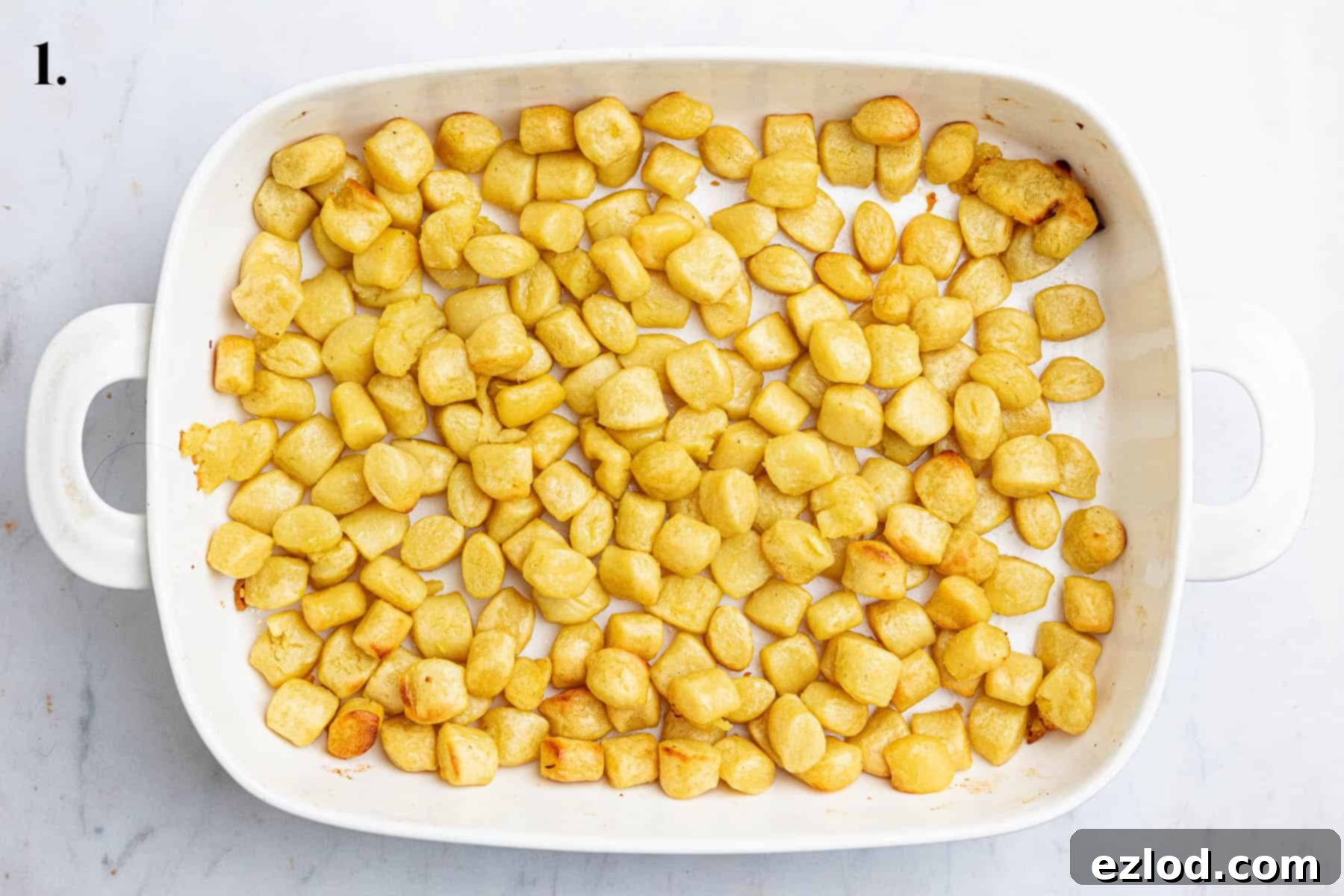 Gooey Vegan Gnocchi Bake 5 Step 1 in making cheesy vegan gnocchi bake: Roasted potato gnocchi spread evenly in a baking dish, golden and lightly crisped.
