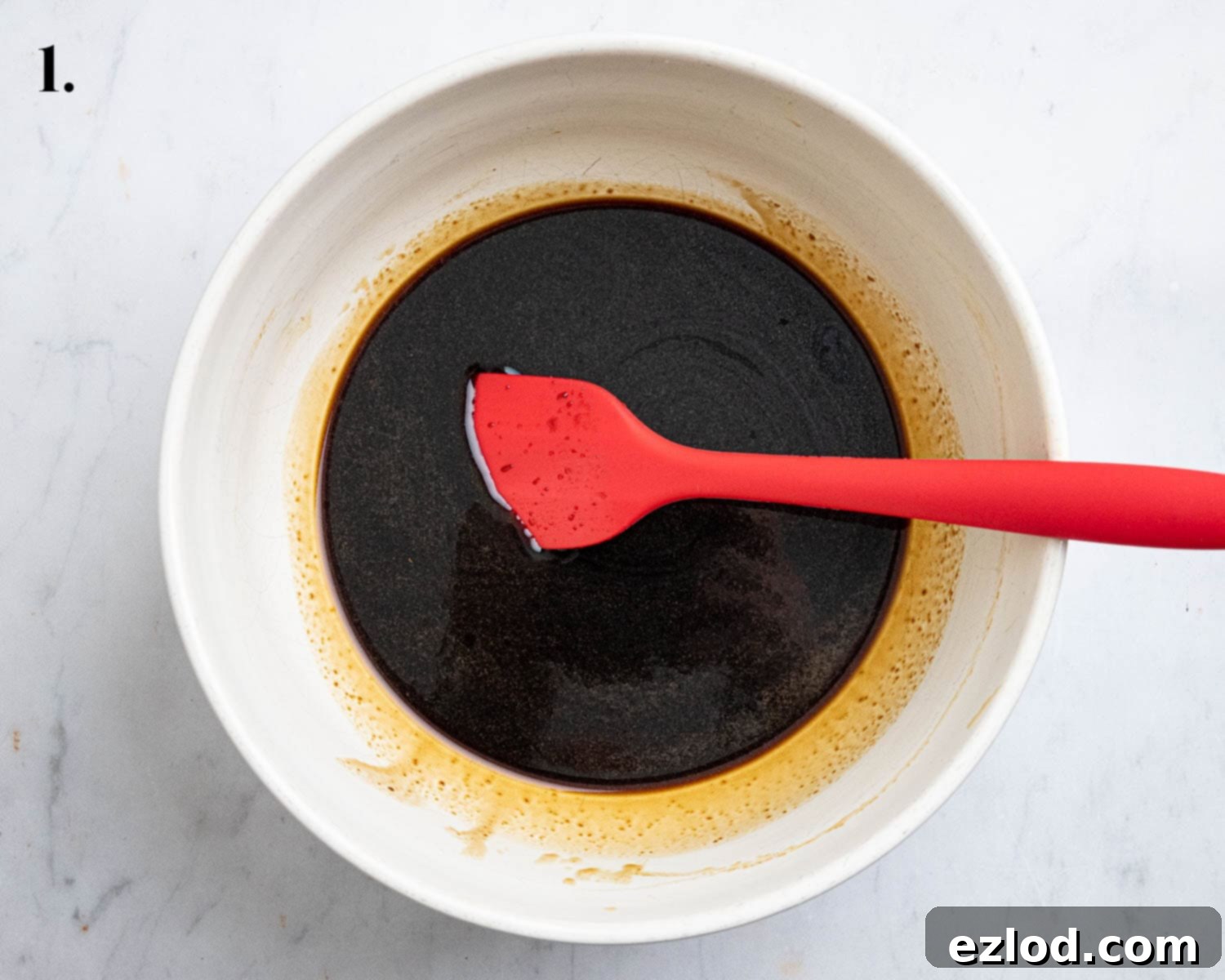 Plant-Based Jamaican Bulla Delight 5 Step 1 in making Jamaican bulla cakes: A bowl containing the mixed wet ingredients – dark liquid molasses, melted butter, and brown sugar – ready for dry ingredients.