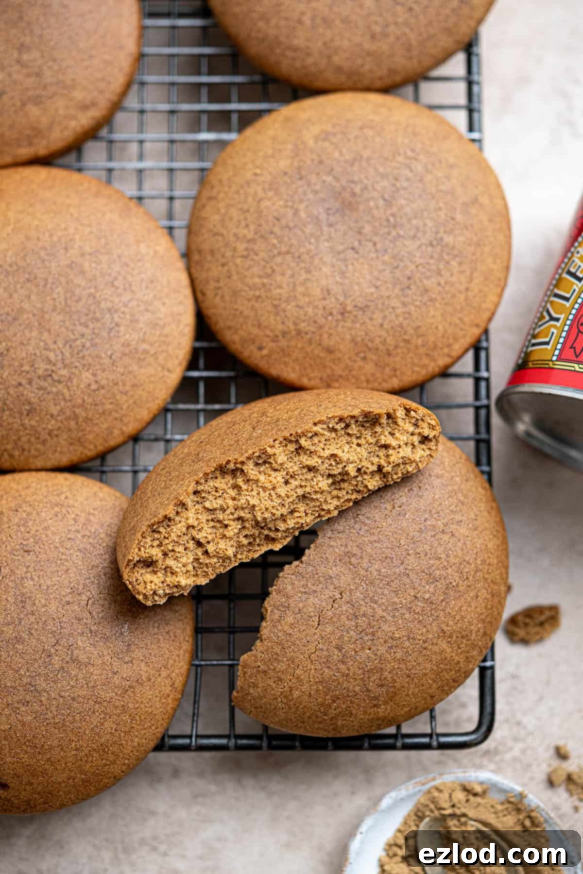 Plant-Based Jamaican Bulla Delight 10 A close-up view of a vegan Jamaican bulla cake, freshly baked and broken in half, revealing its dense, moist, and chewy texture and aromatic ginger-spiced crumb.