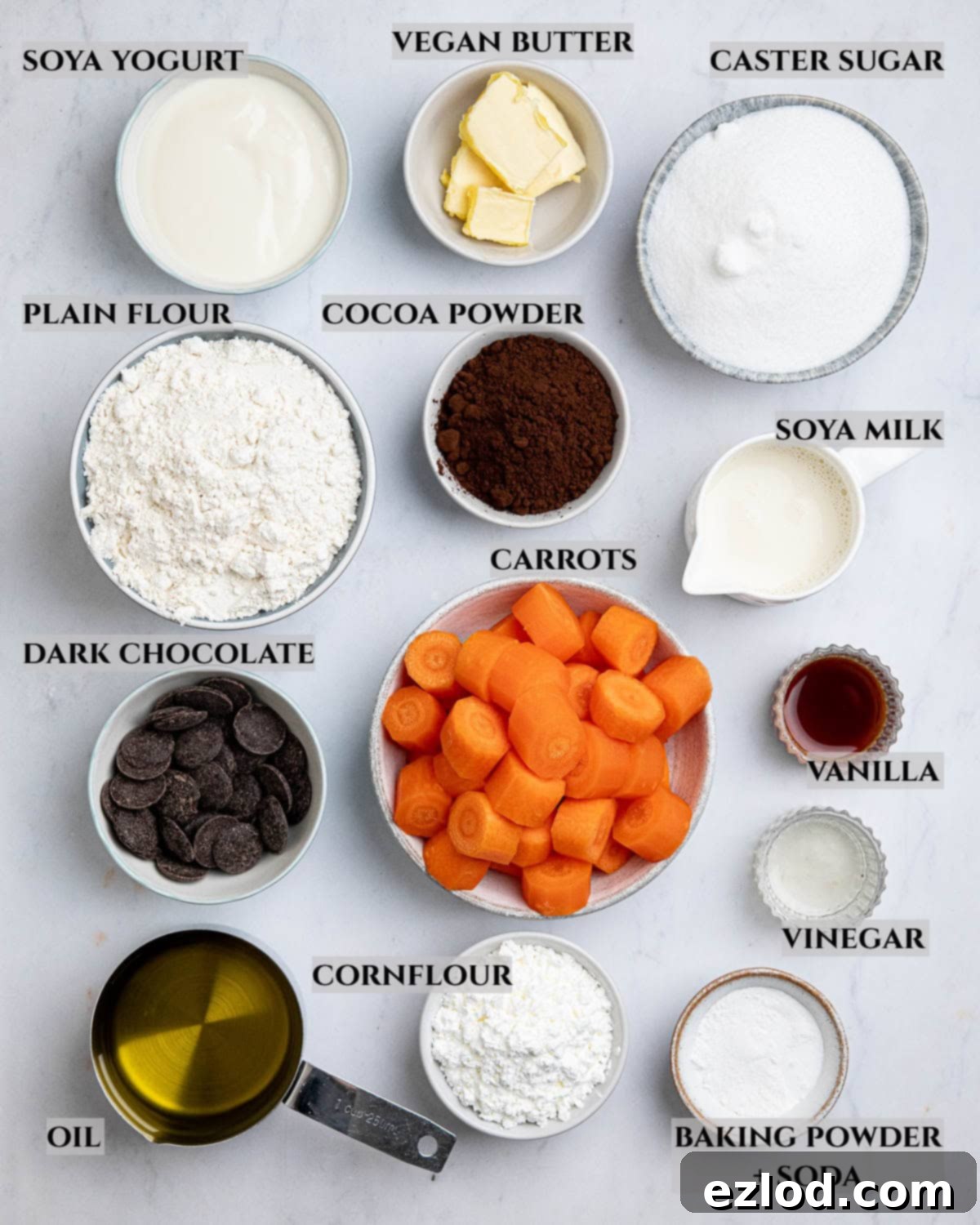 Sun-Kissed Vegan Brazilian Carrot Cake 3 A labelled photo of the ingredients needed to make vegan Brazilian carrot cake in bowls.