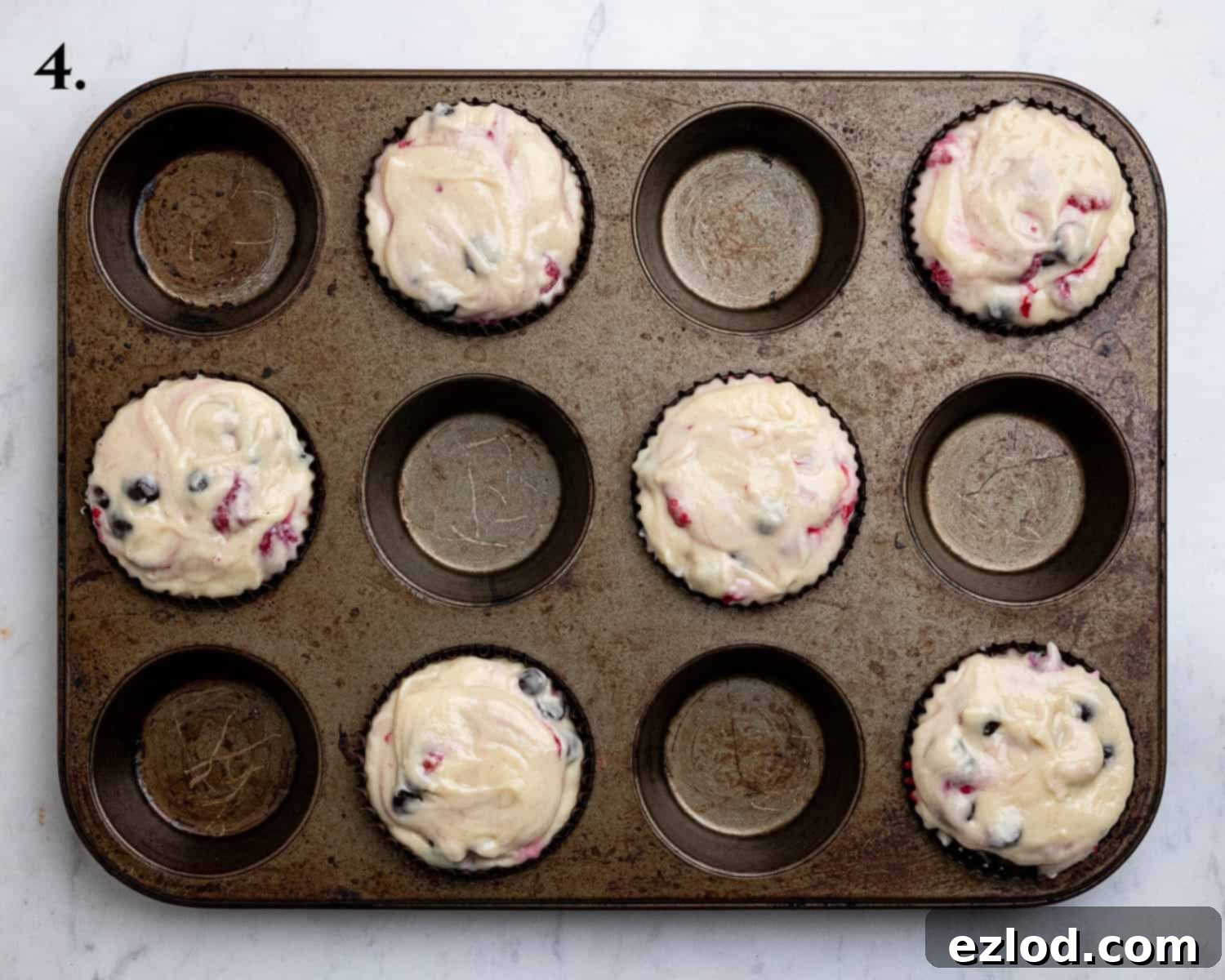 Plant-Based Chocolate Raspberry Muffins 8 Step 4, the batter divided between the muffin cases.