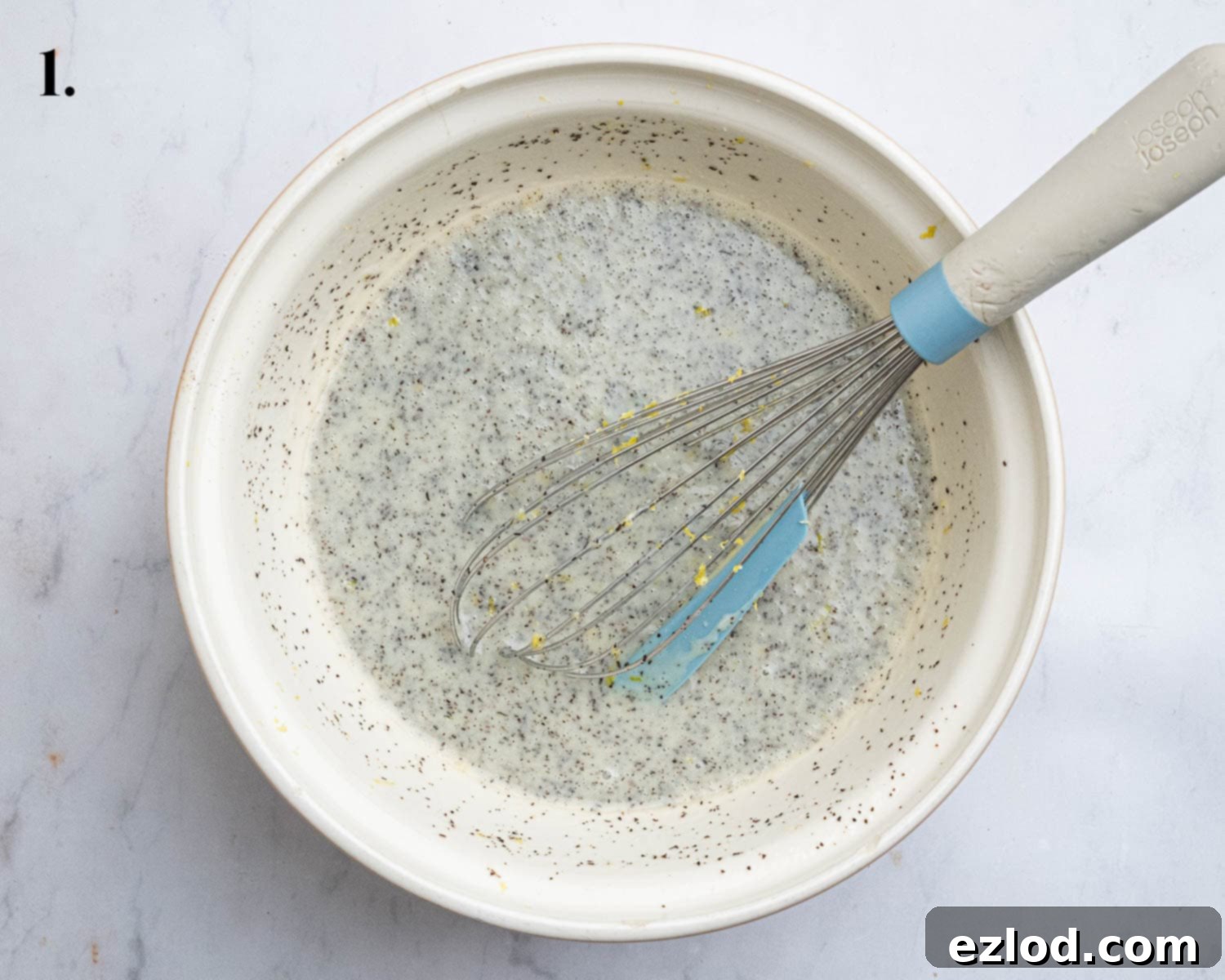 Zesty Vegan Earl Grey Lemon Cake 5 Step 1 in making vegan Earl Grey lemon cake: wet ingredients, including plant yogurt, milk, oil, lemon juice, zest, sugar, and ground Earl Grey tea, are whisked together in a large mixing bowl.