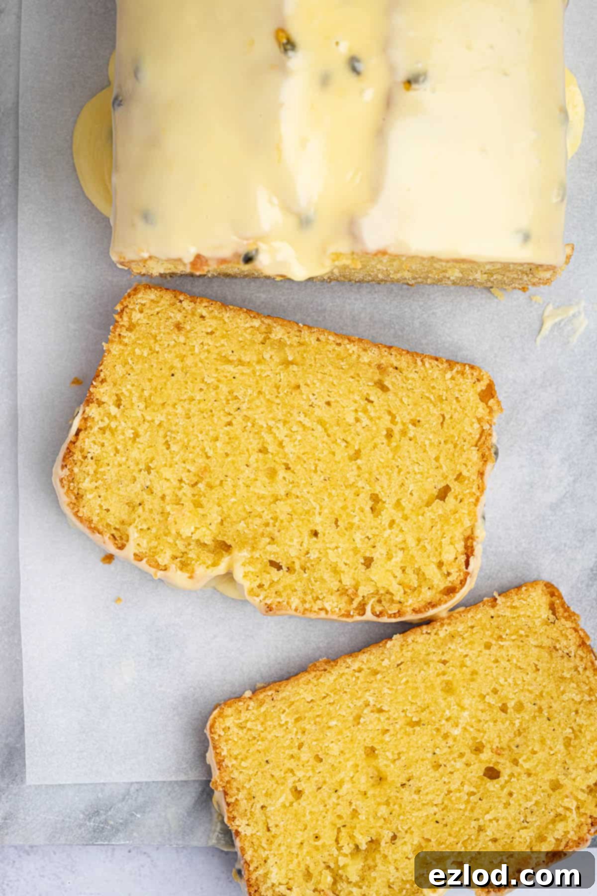 Luscious Vegan Passion Fruit Delight 11 A close-up of a single slice of vegan passion fruit cake, showcasing its incredibly moist, tender crumb and the luscious, seed-speckled passion fruit glaze.