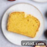 Luscious Vegan Passion Fruit Delight 12 A slice of vegan passion fruit cake on a white plate, showcasing its vibrant glaze and tender crumb.