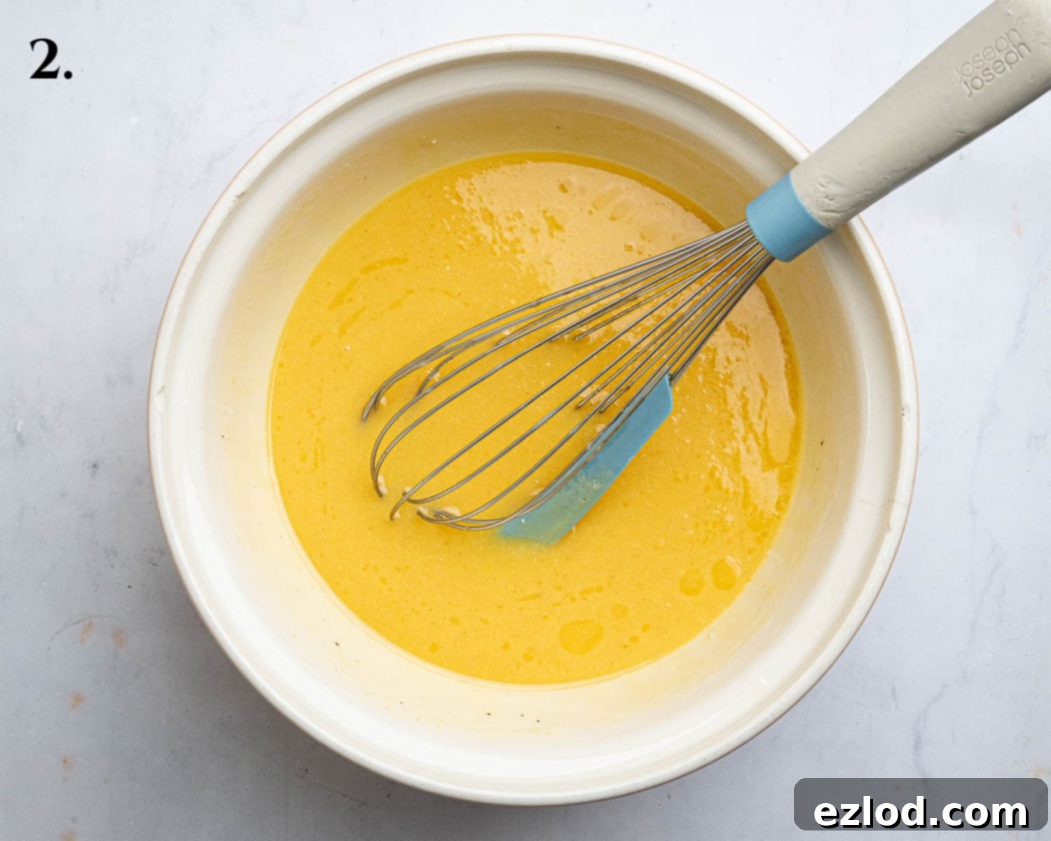 Luscious Vegan Passion Fruit Delight 6 Step 2 in making vegan passion fruit cake: The perfectly combined wet ingredients (passion fruit juice, yogurt, sugar, oil, melted butter, vanilla) in a mixing bowl, ready for dry ingredients.