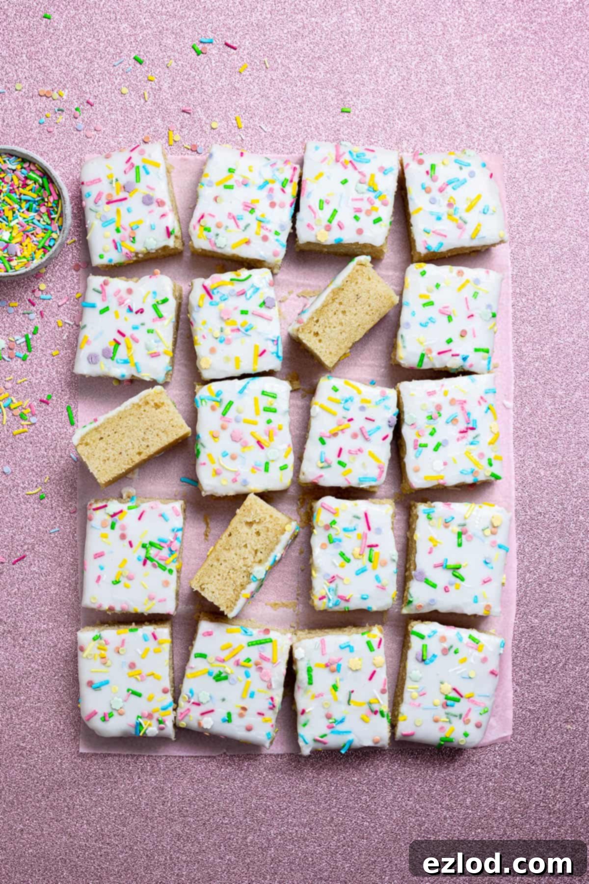 Classic Vegan School Treat 11 Vegan school cake on a pink background with a bowl of sprinkles.