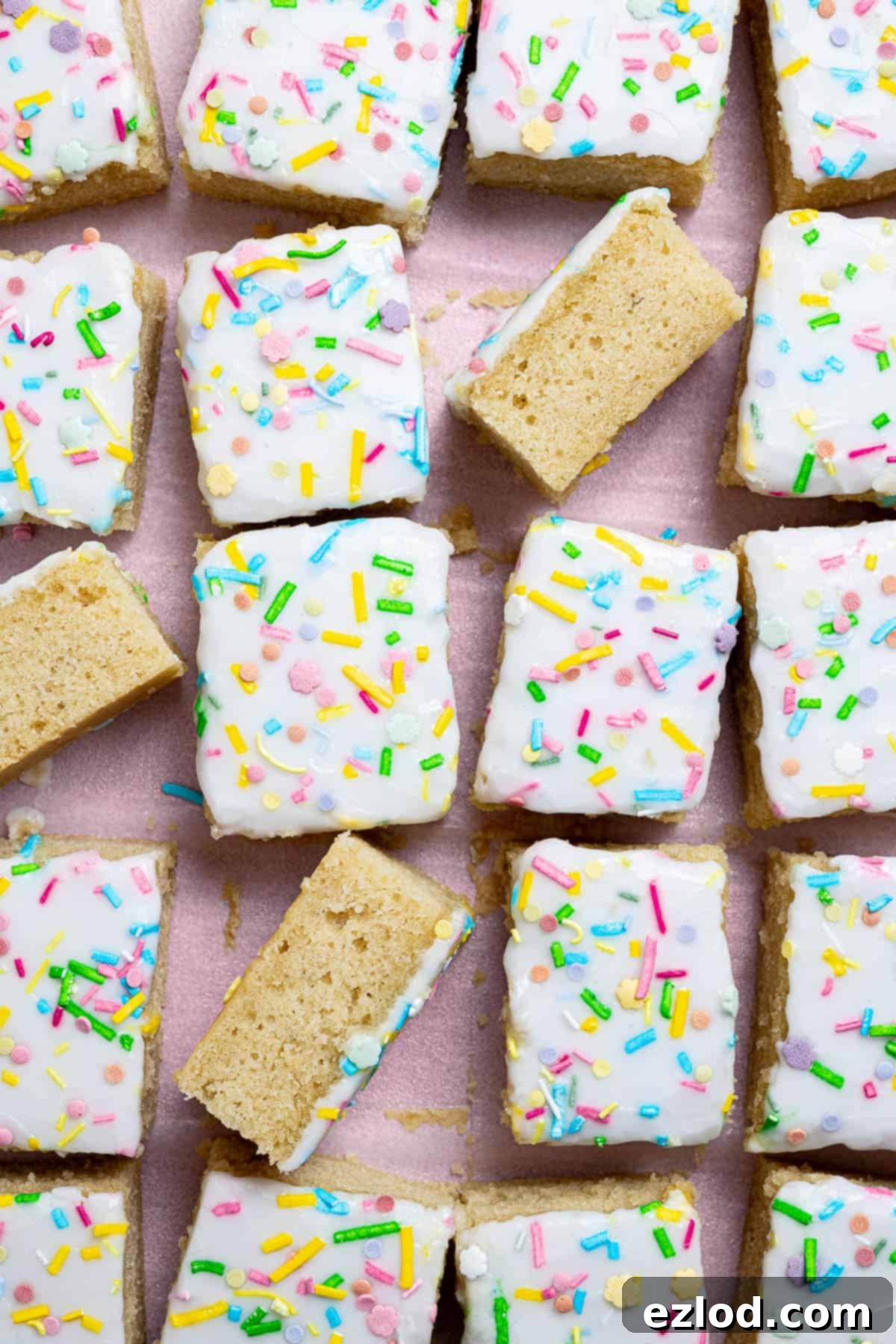 Classic Vegan School Treat 13 Squares of vegan school cake on a sheet of baking paper.
