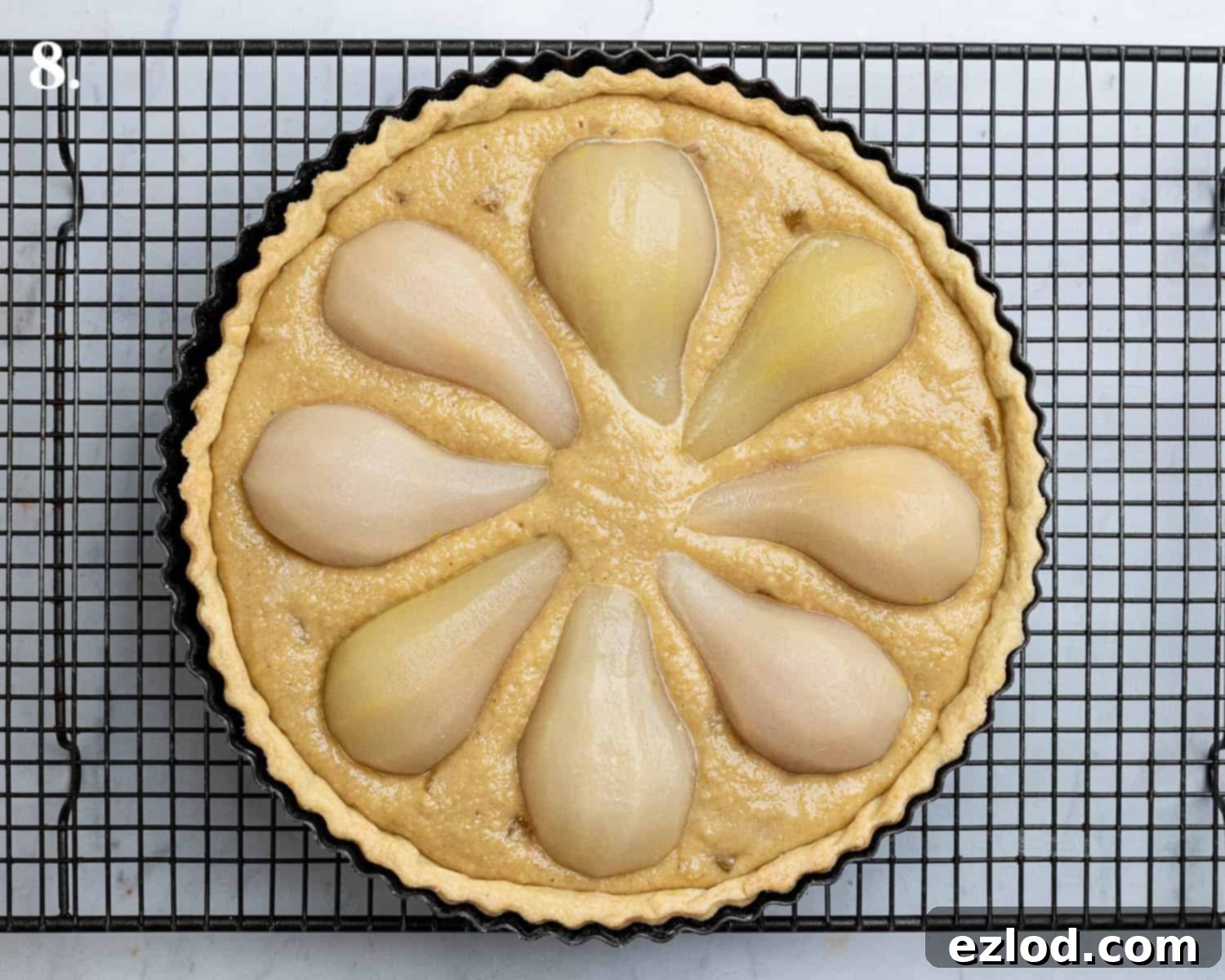 Gingered Pear & Almond Vegan Tart 12 Step 8: The assembled tart before baking, with frangipane spread in the pastry and pear halves arranged on top.