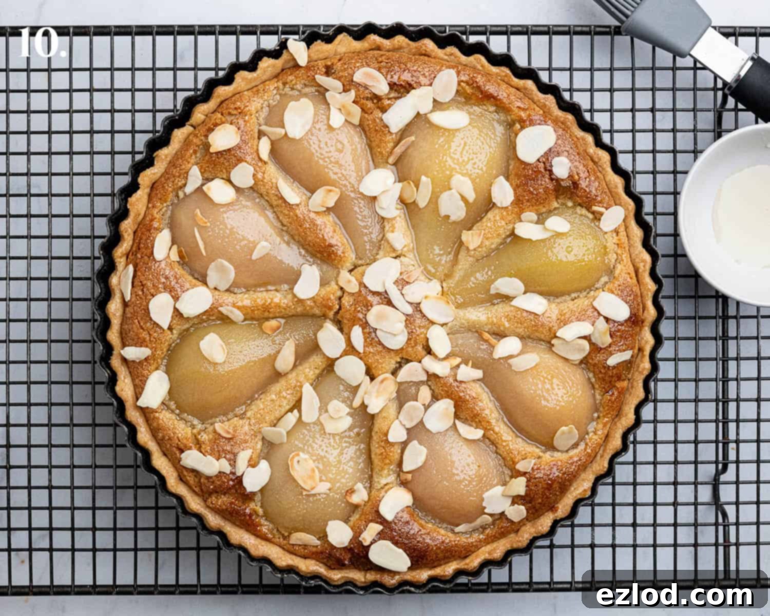 Gingered Pear & Almond Vegan Tart 14 Step 10: The finished tart, brushed with syrup and adorned with toasted flaked almonds.