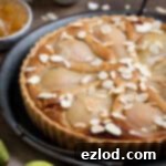 Gingered Pear & Almond Vegan Tart 17 Close up of the vegan pear, ginger and almond tart on a metal tray.