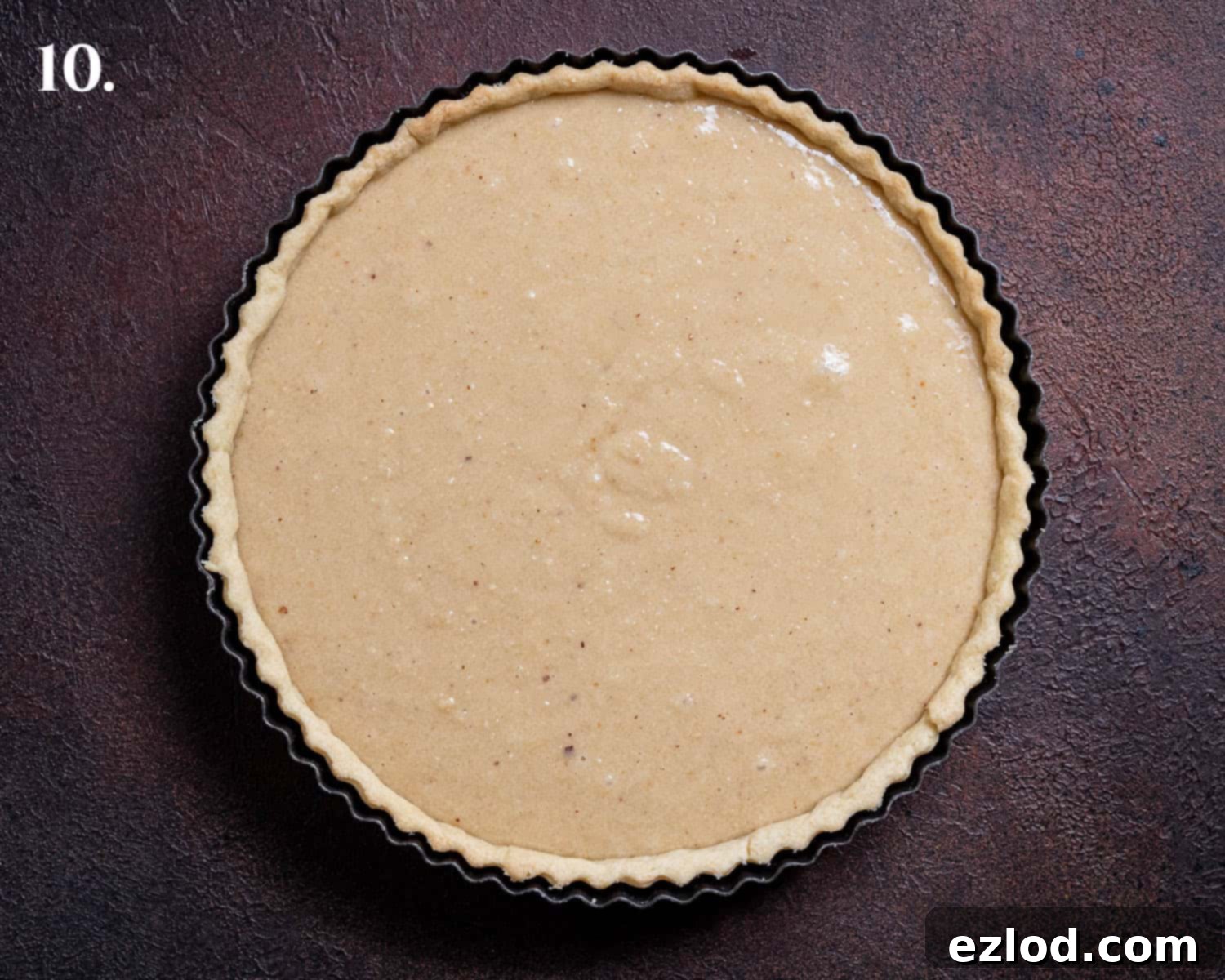 Elegant Vegan Apple Hazelnut Frangipane Tart 14 Step 10: The pastry case generously filled with the smooth, uncooked frangipane mixture, ready for the apple topping.