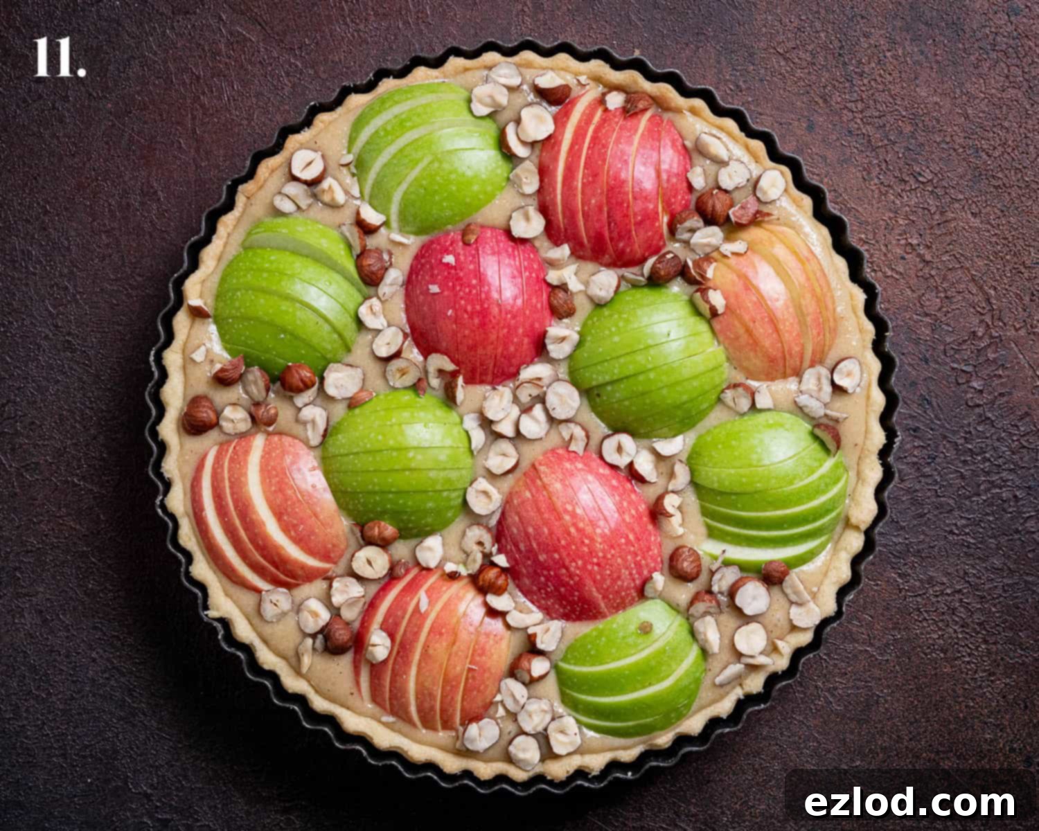 Elegant Vegan Apple Hazelnut Frangipane Tart 15 Step 11: The unbaked tart, beautifully arranged with apple slices pressed into the frangipane and topped with chopped hazelnuts.