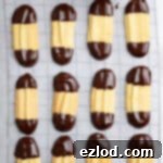 Vegan Chocolate Orange Viennese Fingers 12 Chocolate orange Viennese fingers on a sheet of baking paper.