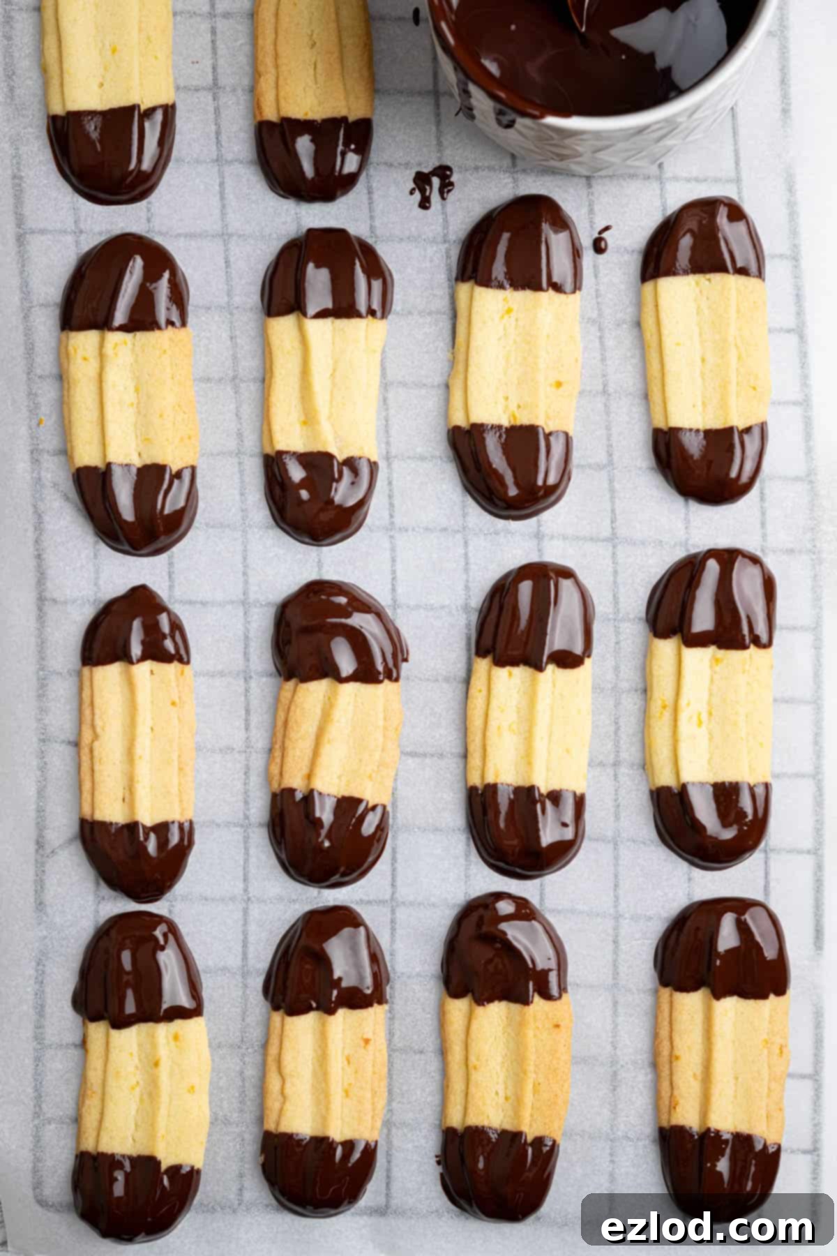 Vegan Chocolate Orange Viennese Fingers 10 Chocolate orange Viennese fingers on a sheet of baking paper.