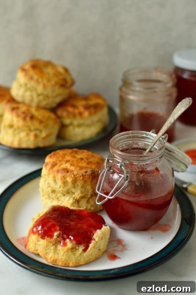 Vibrant homemade strawberry lime jam and fluffy, easy basic scones ready to be enjoyed