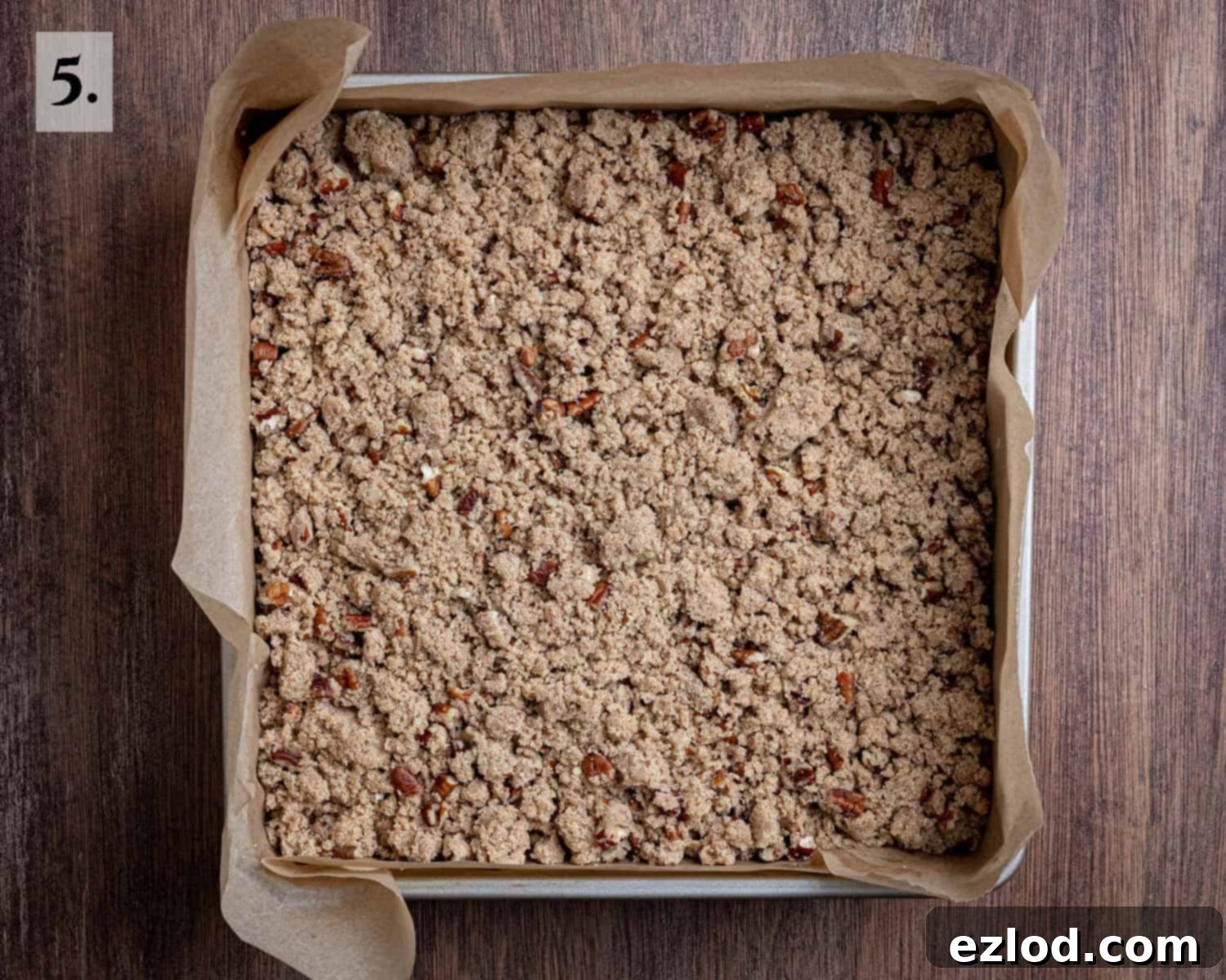 Spiced Vegan Pumpkin Streusel 9 Step 5: The assembled vegan pumpkin crumb cake before baking, with the generous, clumped streusel topping evenly scattered over the smooth cake batter.
