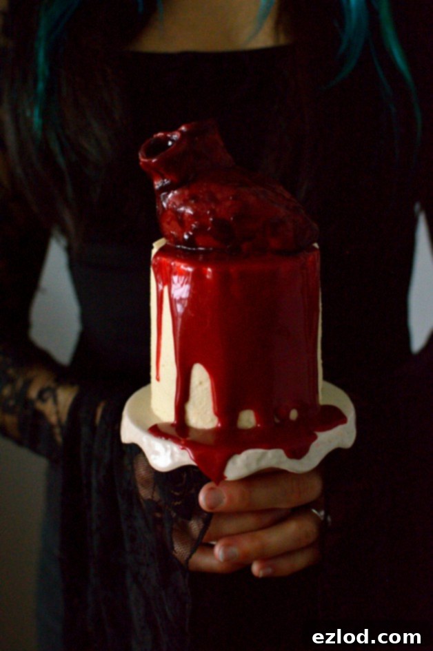 Haunted Heart Halloween Cupcakes 21 Mini red velvet layer cake with ermine frosting topped with a bloody heart and white chocolate ganache 'blood'