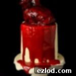 Haunted Heart Halloween Cupcakes 22 Mini red velvet layer cakes with ermine frosting topped with a bleeding heart and ganache 'blood'; perfect for Halloween