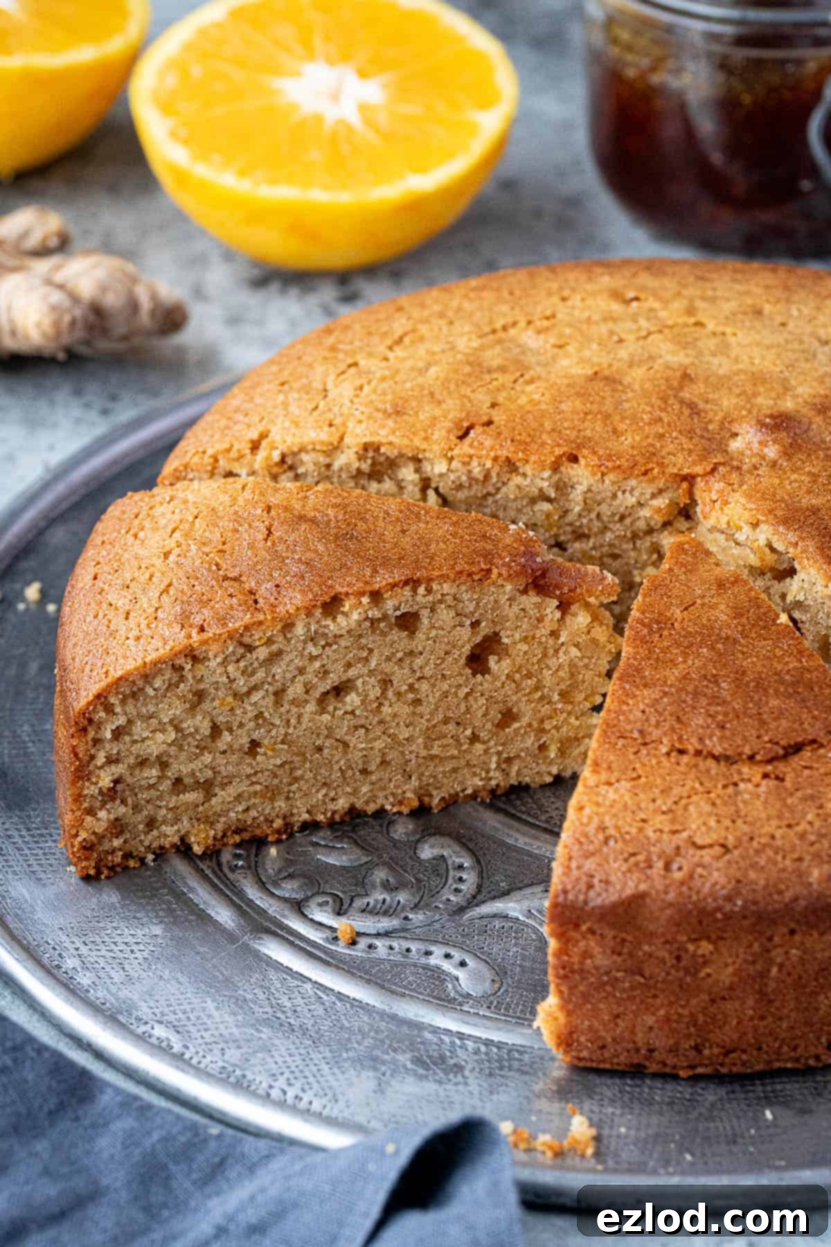 Sun-Kissed Vegan Ginger Cake with Tangy Marmalade 8 A close-up view of a perfectly sliced vegan marmalade and ginger cake, revealing its moist and tender crumb.