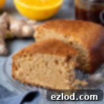 Sun-Kissed Vegan Ginger Cake with Tangy Marmalade 10 A slice of marmalade and ginger cake with a forkful removed, showcasing its delightful texture.
