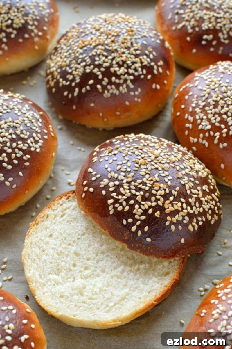 Cloud-Soft Tangzhong Burger Buns 2 Close-up of freshly baked Tangzhong burger buns, showing their golden-brown tops and soft texture.