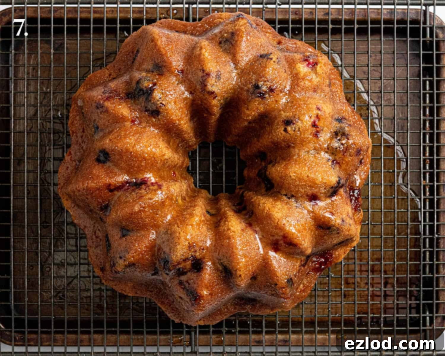 Vegan Berry Lime Bundt Cake 11 Step 7 in making berry lime bundt cake: the freshly baked cake generously covered with the tangy lime drizzle, creating a beautiful glaze and enhancing moisture.