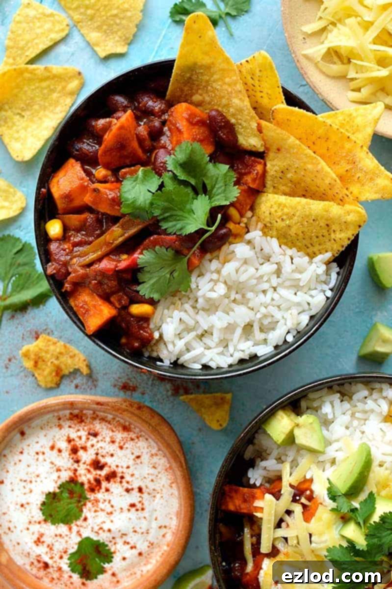 Effortless Veggie Chili and 5 Smart Leftover Dishes 6 Easy veggie chilli recipe served with rice, tortilla chips, avocado, and sour cream, showcasing a healthy and satisfying meal.
