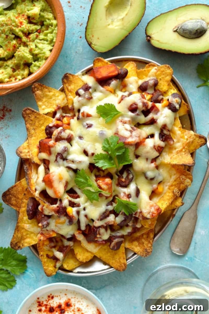 Effortless Veggie Chili and 5 Smart Leftover Dishes 8 Veggie chilli topped nachos in an oven-proof dish, with guacamole and sour cream on the side, a perfect leftover meal.