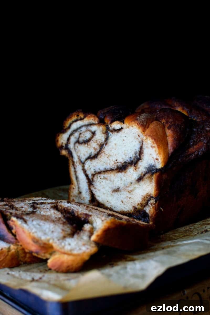 Marbled Nutella Banana Yeast Bread 7 A large slice of Nutella Swirled Banana Yeast Bread on a plate, revealing the soft interior and generous Nutella layers.