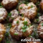 Garlic Herb Parmesan Smashed Potatoes 7 Crispy and creamy Herby Parmesan Smashed Potatoes on a plate.