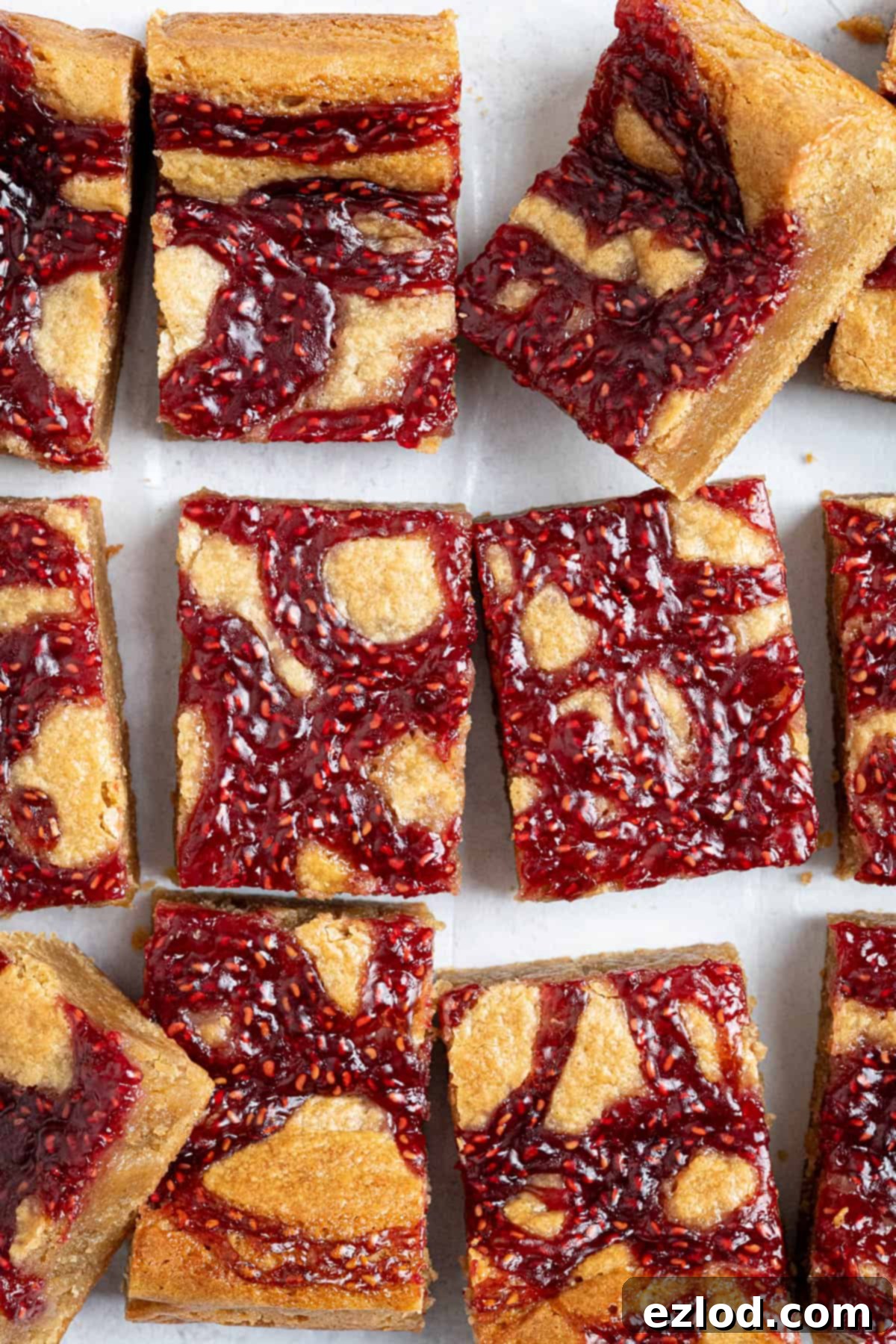 Irresistible Vegan Peanut Butter Blondies 12 A close-up view of sliced vegan peanut butter jam blondies, showing the vibrant jam swirls and rich texture.