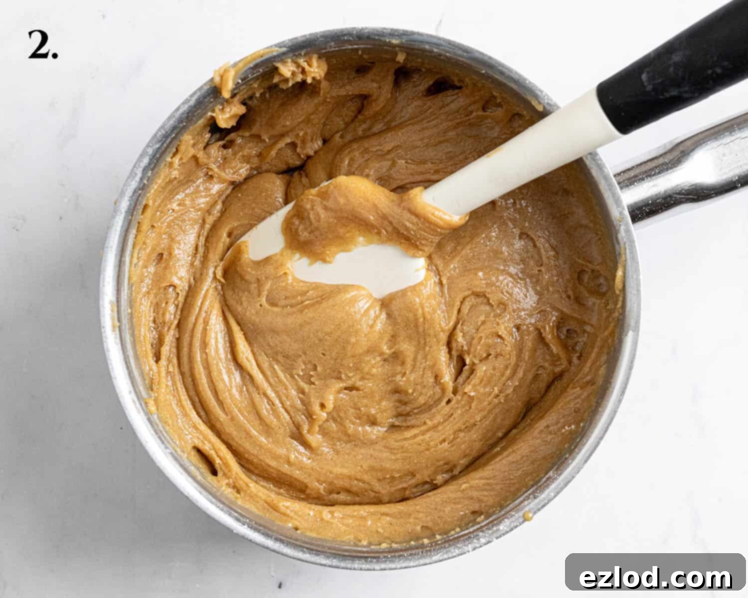 Irresistible Vegan Peanut Butter Blondies 6 Step 2: The finished blondie batter, a thick and smooth mixture, is visible in the pan after incorporating all dry ingredients.
