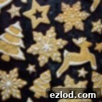 Buttery Orange Cinnamon Biscuits 7 A small, mouth-watering image of orange cinnamon butter biscuits in various festive shapes, adorned with delicate white royal icing, perfect for a quick glance at the final product.