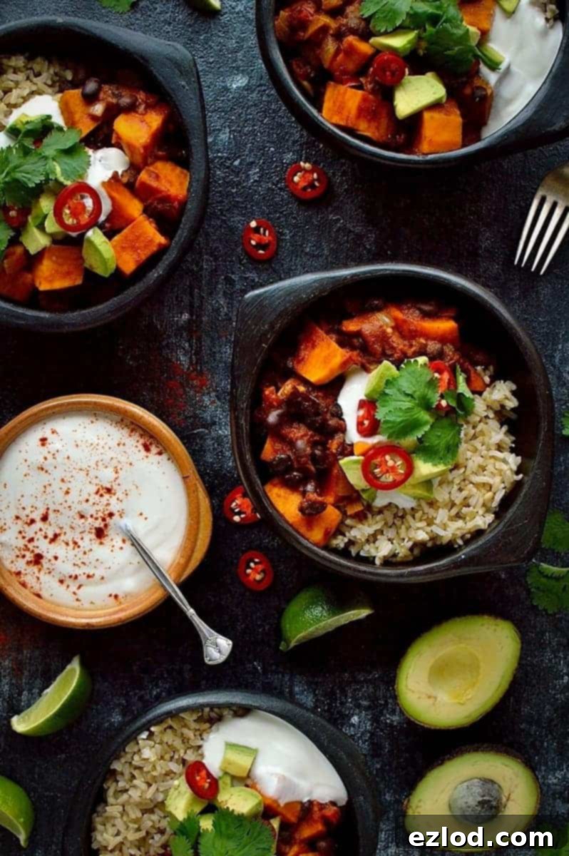 Hearty Vegan Sweet Potato Black Bean Chili 2 Sweet potato black bean chilli served in a black bowl, garnished with fresh cilantro and a dollop of vegan sour cream. A hearty, warming, healthy, and delicious vegan meal.