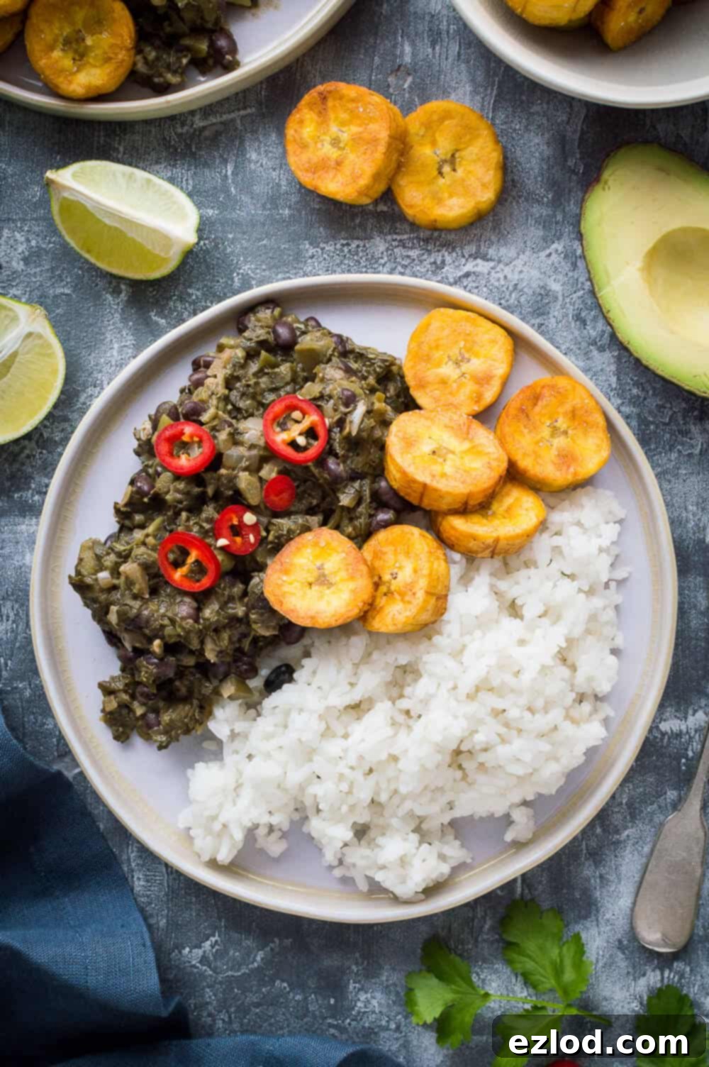 Aromatic Caribbean Medley with Coconut Rice and Sweet Plantain 3 A plate of vegan spiced black beans and callaloo with coconut rice, fried plantain and red chilli.