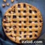 Vegan Blueberry Pie with a Flaky Coconut Oil Crust 14 Unsliced baked vegan blueberry pie topped with a coconut oil pastry lattice and pastry braids and hearts.