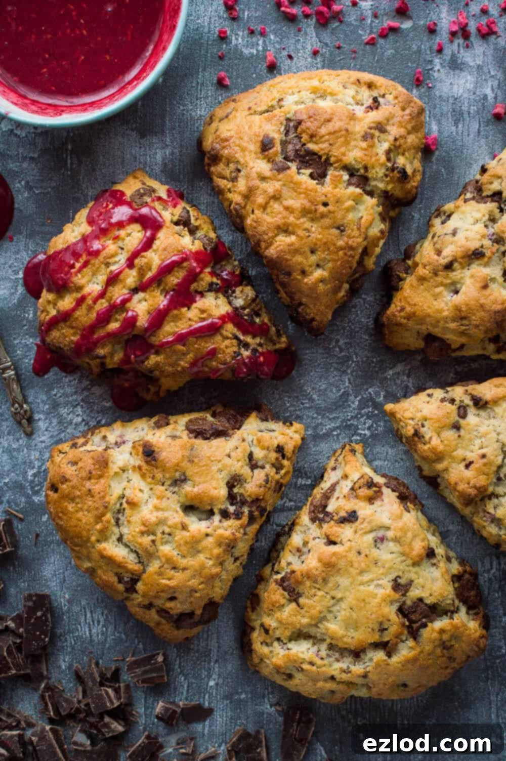 Decadent Vegan Chocolate Raspberry Scones 9 six vegan/dairy free coconut oil chocolate raspberry scones, one drizzled with raspberry glaze.