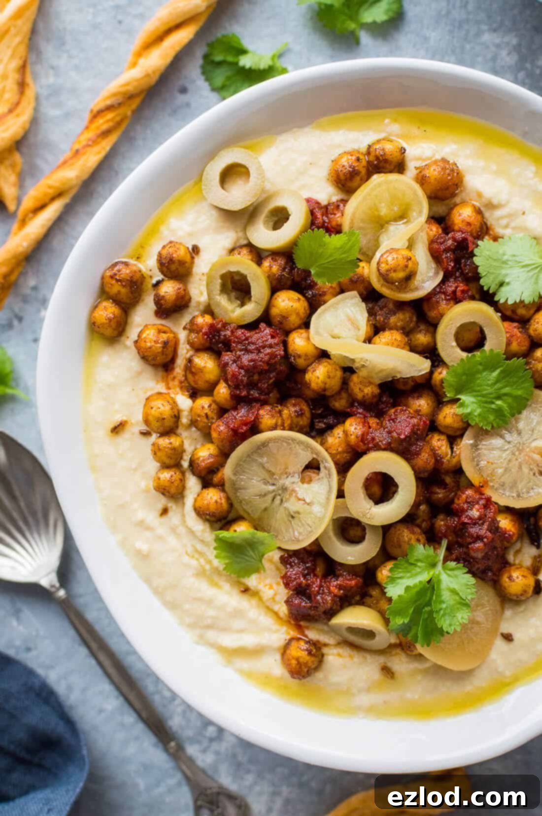 Hummus Bowl with Crispy North African Chickpeas and Fiery Caraway Jam 4 close up of loaded hummus bowl with spiced crispy roasted chickpeas, preserved lemon and olives
