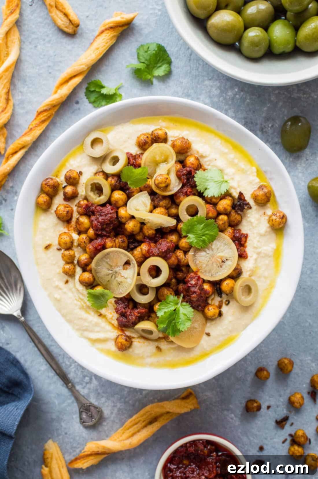 Hummus Bowl with Crispy North African Chickpeas and Fiery Caraway Jam 5 Hummus topped with crispy Ras el hanout roasted chickpeas, preserved lemon, olives and olive oil