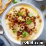 Hummus Bowl with Crispy North African Chickpeas and Fiery Caraway Jam 6 Hummus topped with crispy Ras el hanout roasted chickpeas, preserved lemon, olives and olive oil