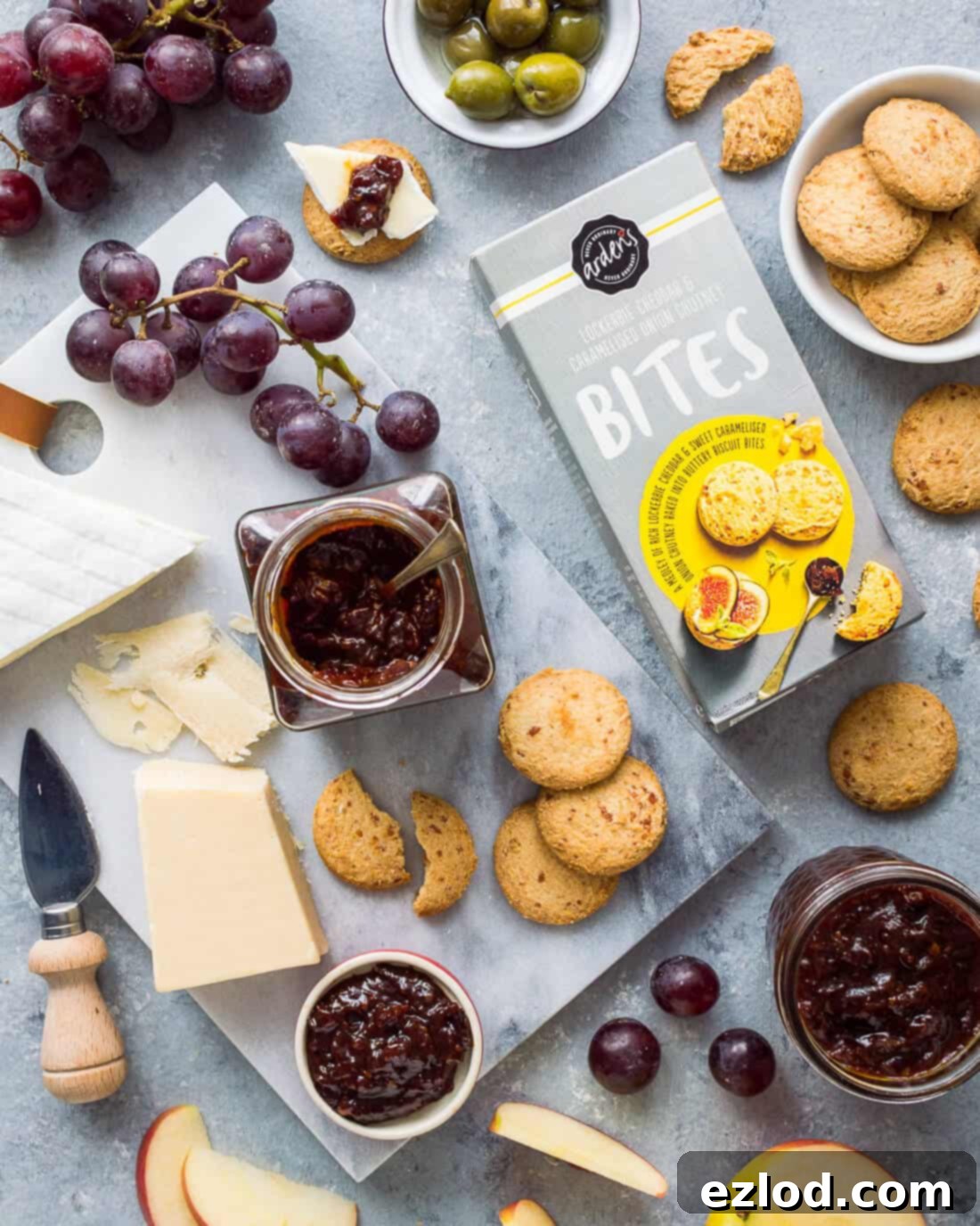 Hummus Bowl with Crispy North African Chickpeas and Fiery Caraway Jam 9 Flatlay of tomato, chilli and caraway jam with cheeses, grapes, apple and Arden's Lockerbie cheddar and caramelised onion chutney bites