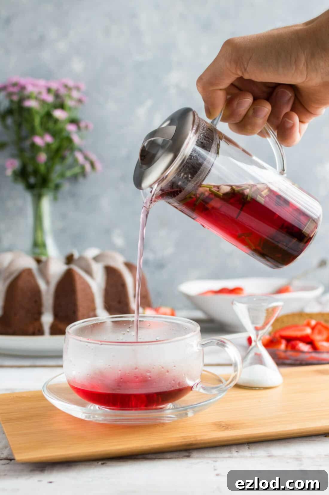 Vegan Ginger Bundt with Zesty Lime Drizzle and Sweet Strawberries 4 JING Green Apple and Hibiscus herbal tea being poured into a glass teacup